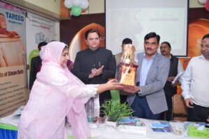 Dr. Nuzhat Akhtar Presenting Memento to the DM Aligarh 300x200 1